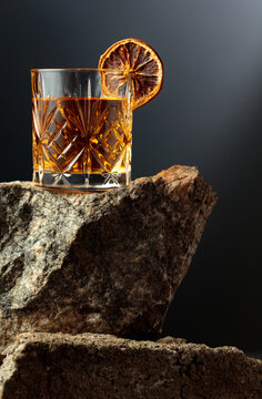 Old-fashioned cocktail with dried orange slice.
