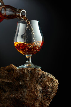 Glass of brandy on a rough granite.