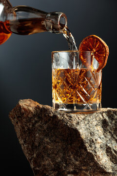 Old-fashoned cocktail on a rough granite.