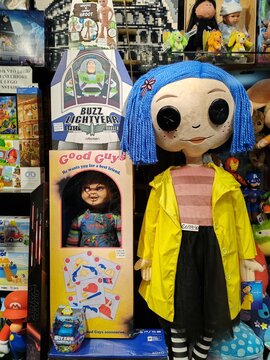 Rome, Italy - June 20, 2025, some collectible toys, including Child's Play, Buzz Lightyear, and a dark doll, in anticipation of the Halloween party, in the window of a collectible toy shop.