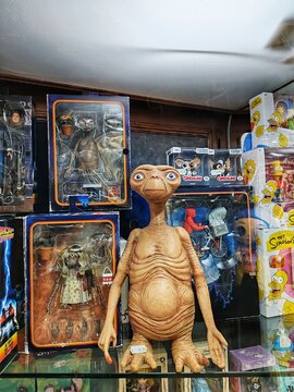 Rome, Italy - July 15, 2025, detail of the window of a collectible toy shop with various very famous characters such as E.T. the extra-terrestrial in the foreground on the shelf in the window.