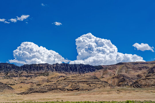 Bright cumulonimbus clouds rise above a ridge in Skull Valley, Utah, USA