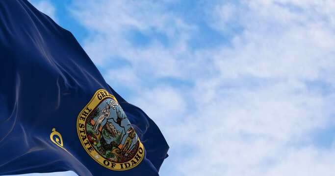 Close-up of the Idaho state flag waving in the wind on a clear day