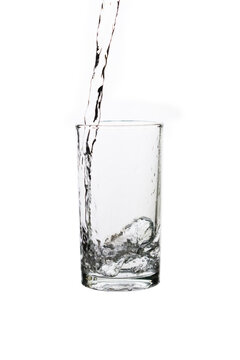 Pouring fresh drinking water into a clear glass isolated on a white background. Hydration, purity, refreshment, and healthy lifestyle concept.