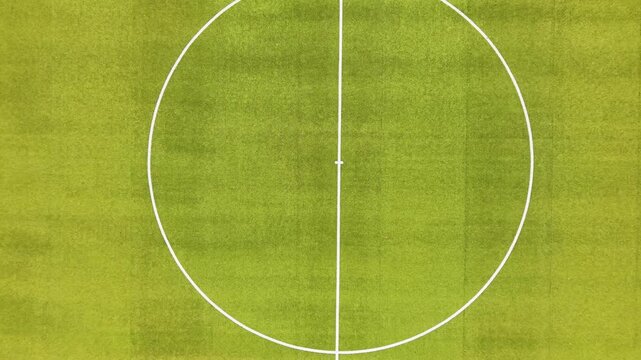 Aerial top down view of the center circle of an empty football pitch