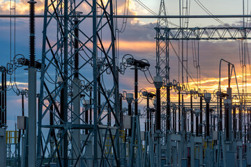 An electrical substation featuring steel towers, transformers, and power lines against a golden sunset sky in Villa Hayes, Paraguay. © Jose Luis Stephens