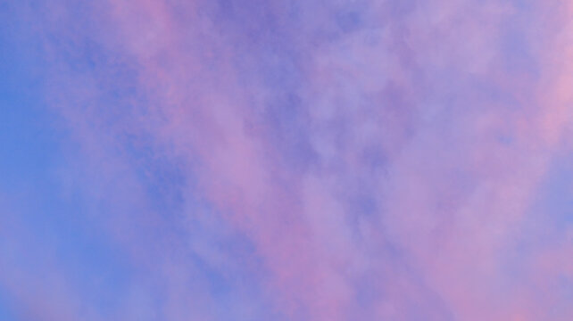 Soft pink and blue clouds drift across the sky at dusk