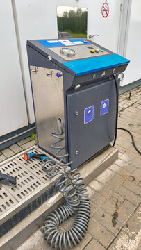 Stationary automatic compressor for inflating tires at gas station. Equipment for checking tire pressure. Maintenance tool at automotive service center to manage vehicle safety daily