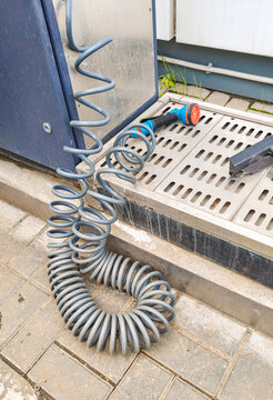 Station compressor hose for inflating tire on a gasoline station. Automatic air pump device for car maintenance and wheel pressure service. Industrial equipment for traveler on road trip
