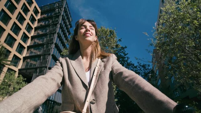 Video of beautiful woman riding a bicycle through the city.