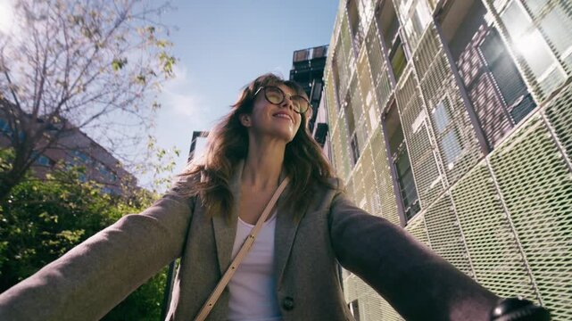 Video of beautiful woman riding a bicycle through the city.