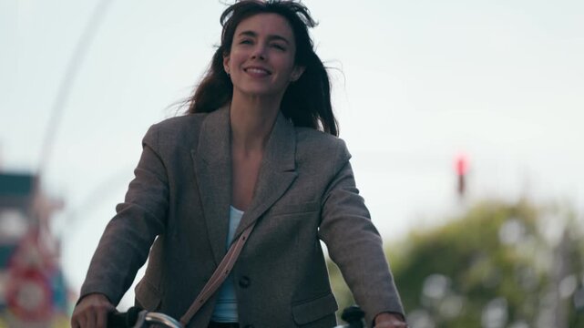 Video of beautiful woman riding a bicycle through the city.