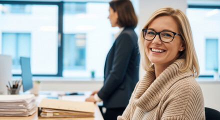 Obraz premium Two women talk in bright office with stacks of papers. One person smiles friendly while discussing important topics. They work on project planning.