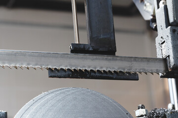 Naklejka premium Thin, round metal discs cut with abandsaw, with metal shavings and lubricant on them. tech industrial technology background