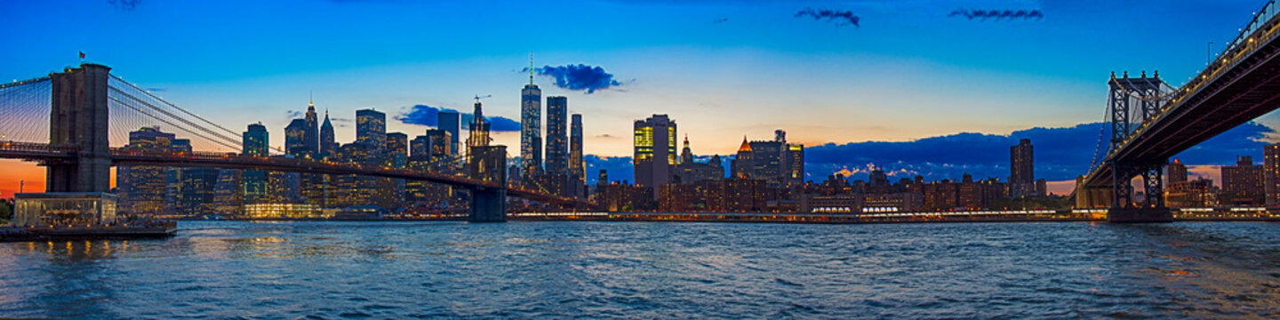 panoramic view of Brooklyn and Manhattan Bridges over the East River at sunset