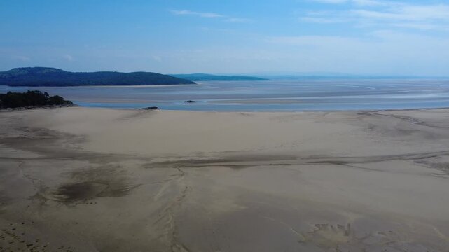 Aerial view of the beach at Grange over Sands showing the intertidal zone of the North side of Morecambe bay and the Arnside Knott on the other side of the river