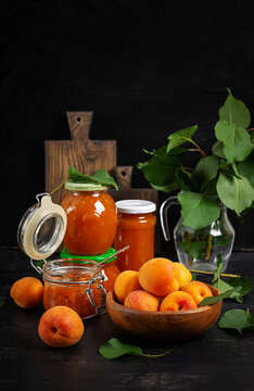 Fresh Apricots and Apricot Preserve on Rustic Dark Background