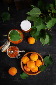 Homemade Apricot Marmalade in Jars on Dark Background. Top view