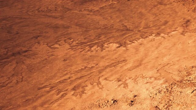 The scene captures the surface of Mars with various patterns formed in the red soil. The landscape displays textures and colors that are characteristic of the Martian terrain during daylight.