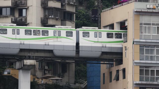 train enters liziba station inside a building on bridge in Chongqing china