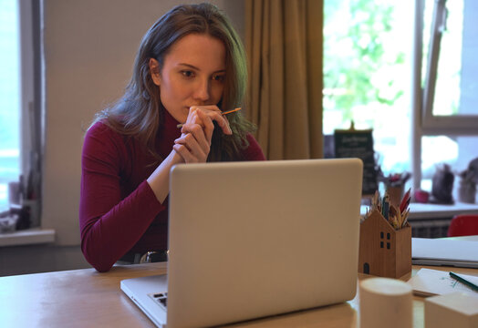 Focused businesswoman overworking on laptop at home office
