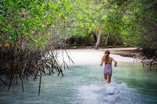 Running through the water, girl in Galapagos