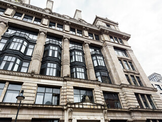 Obraz premium Grand historic ommercial building facade with columns and bay windows in Manchester, UK city centre architecture