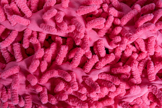 Pink microfiber chenille textile surface with dense curly tuft loops