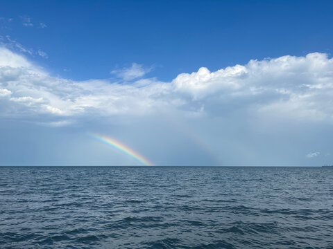 Wide Seascape with Rainbow and Clouds