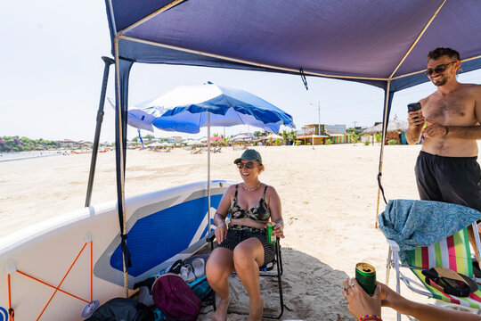 Relaxing under beach canopy with friends in Ecuador