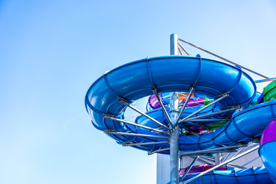 Blue Water Slide Structure At Outdoor Aquapark Summer Recreation And Leisure Background