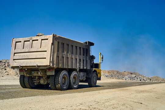 Heavy-duty dump truck in open-pit copper mine landscape
