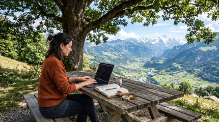 Fototapeta premium Woman working on laptop at wooden picnic table under tree overlooking mountain valley and winding river, outdoor remote work scene with scenic hillside view and focused mood