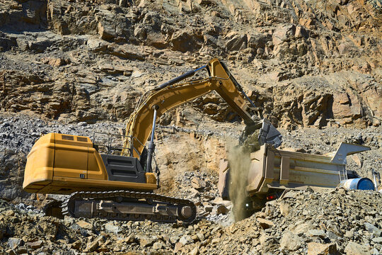 Excavator loading rock in open-pit copper mining operation