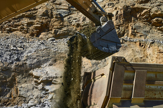 Excavator loading earth at an open-pit copper mine