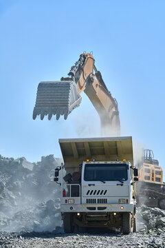 Excavator loading truck in open-pit copper mining