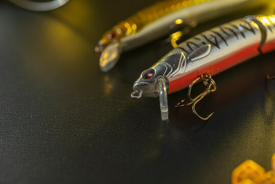 Two hard bait fishing lures on a dark surface The Concept of angling