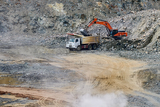 Excavator and truck in open-pit copper mine