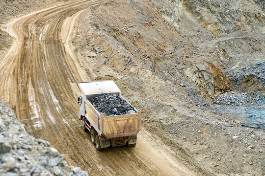 Mining truck hauls copper ore in open-pit landscape