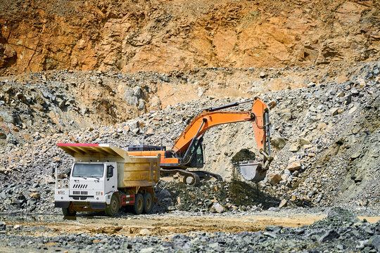 Excavator and dump truck in an open-pit copper mine