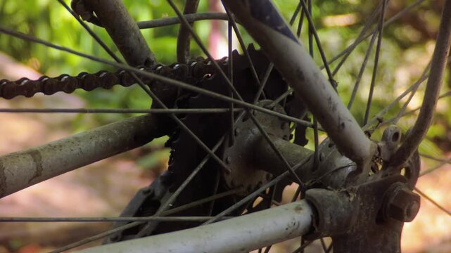 Detailed view of a dusty and worn-out vintage bicycle rear wheel hub and chain