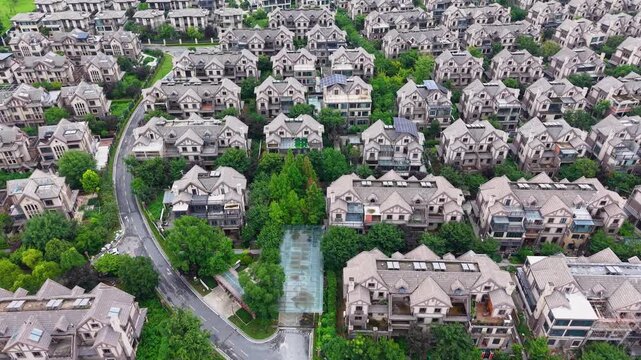 Aerial top-down view of European style villa residential district with winding roads and green trees