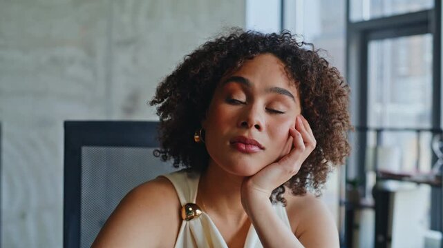 Woman resting hand cheek thinking loft office. Closeup pensive lady portrait.