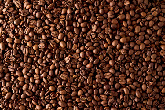 Roasted coffee bean texture background, top view closeup