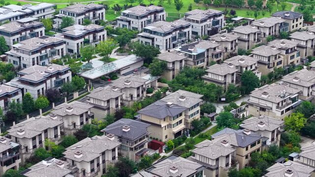 Aerial top-down view of European style villa residential district with winding roads and green trees
