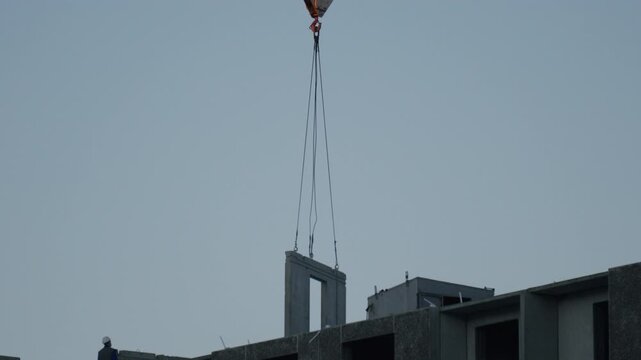 High-rise apartment building under construction with crane