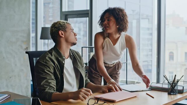 Frustrated colleagues arguing office desk. Stressed man woman conflict work