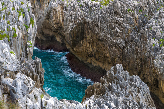 Turquoise flowing water between rugged limestone cliffs