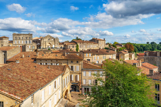 Townscape of Saint Emilion with medieval architecture, terracotta rooftops and dramatic clouds in famous French wine region, Bordeaux, France. Wine tourism, medieval town in Nouvelle-Aquitaine