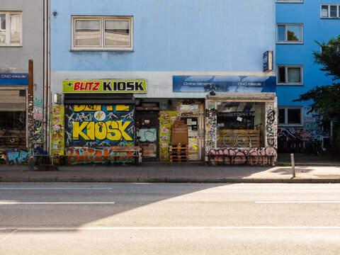 Hamburg, Germany - 07272026: Closed Blitz Kiosk Storefront on Stresemannstra&szlig;e in Hamburg Germany. The colorful kiosk storefront is covered with graffiti.